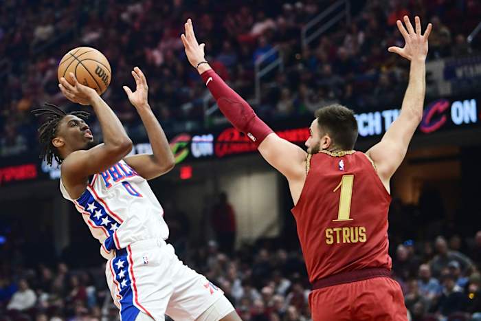 Feb 12, 2024; Cleveland, Ohio, USA; Philadelphia 76ers guard Tyrese Maxey (0) shoots over the defense of Cleveland Cavaliers guard Max Strus (1) during the first half at Rocket Mortgage FieldHouse. Mandatory Credit: Ken Blaze-USA TODAY Sports